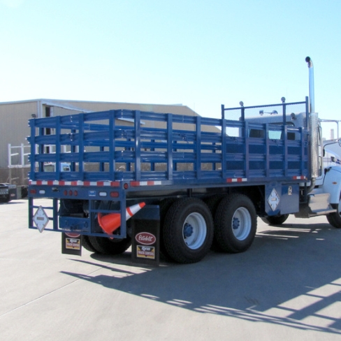 Blue stake bed truck from the back