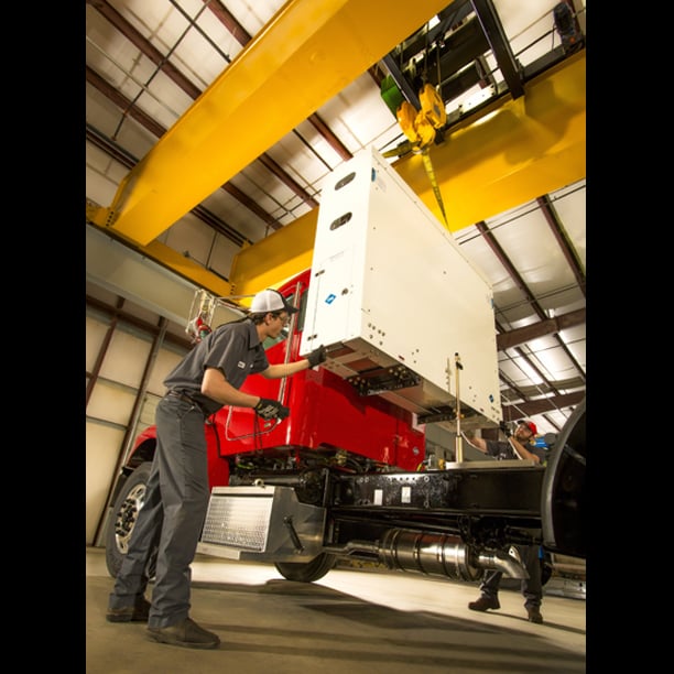 Techs installing CNG fuel system