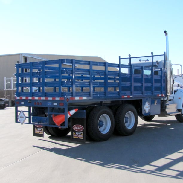 Back view of blue stake bed truck