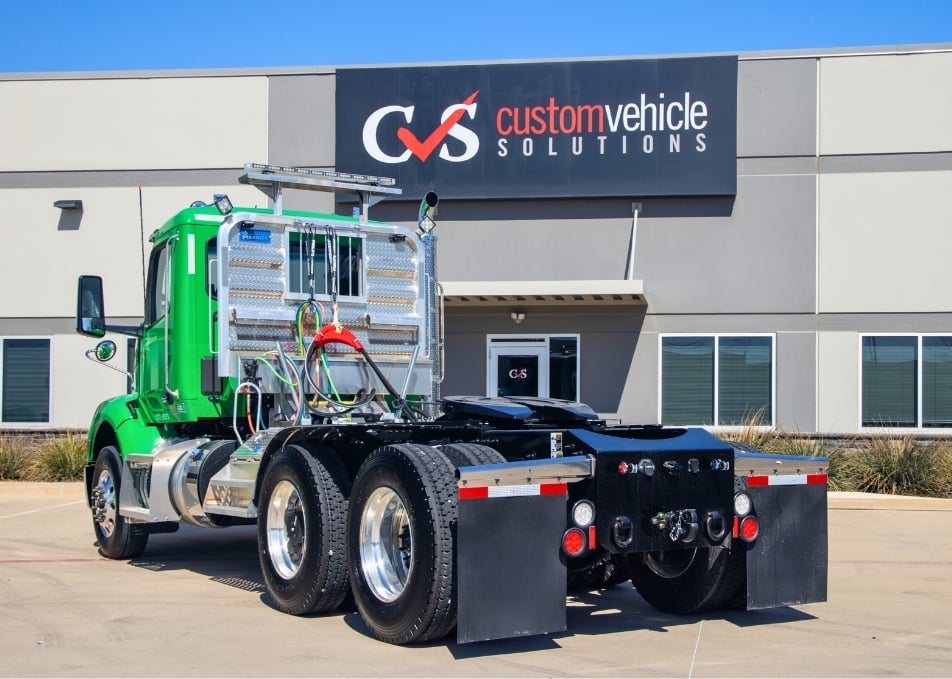 Green Peterbilt truck with winch truck body and Merritt cab rack