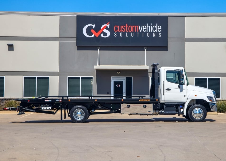 White Peterbilt truck with Jerr-Dan flatbed tow truck
