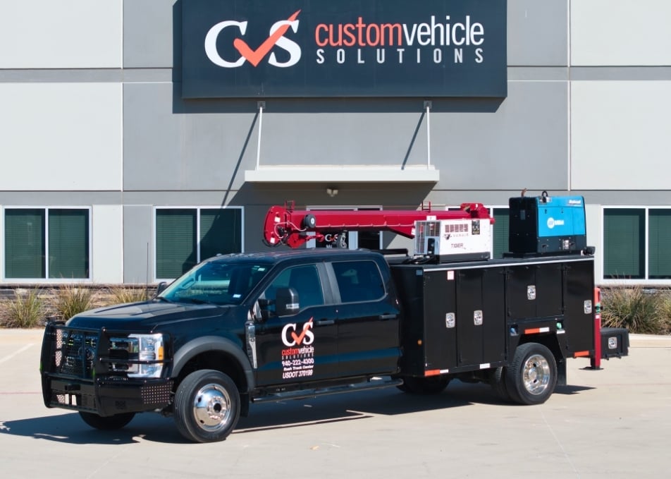 Black Ford truck with black mechanics truck body with red crane
