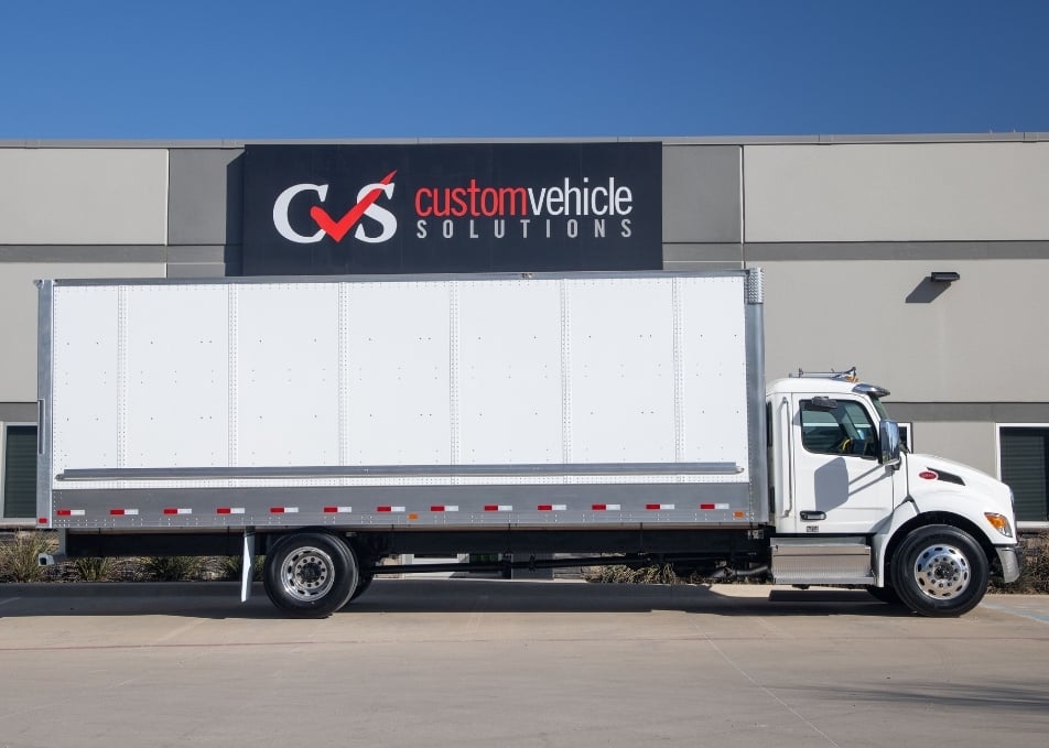 Side view of white Peterbilt truck with Hyundai van body/box truck body