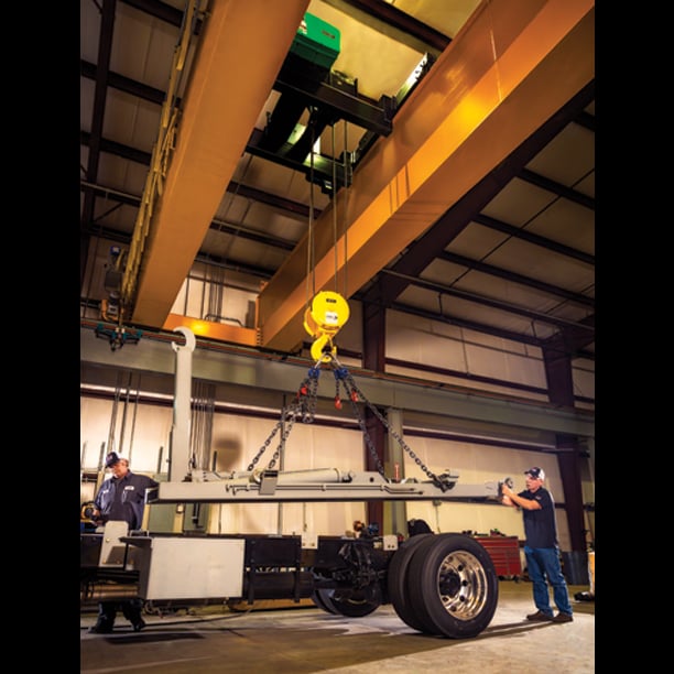 Techs installing truck body with hook lift