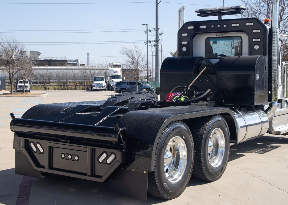 Winch truck body with custom fenders and headache rack with warning light