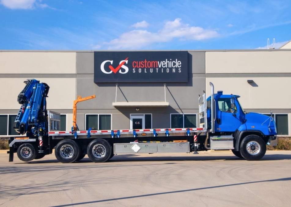 Side view of flatbed truck with Fassi knuckle boom crane installed on back