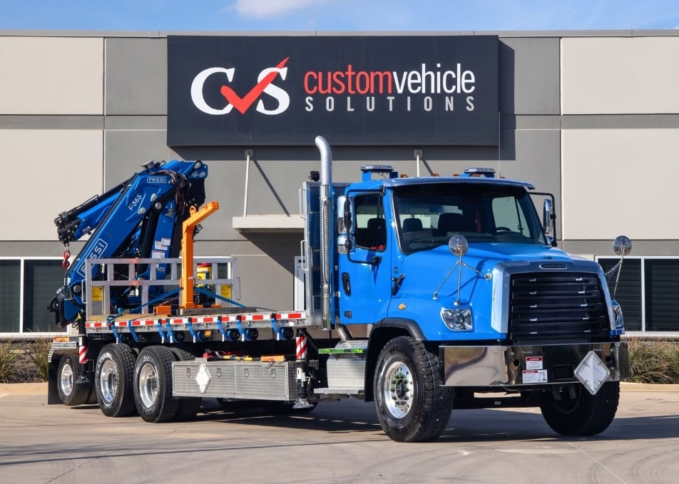 Front view of flatbed truck with Fassi knuckle boom crane installed on back