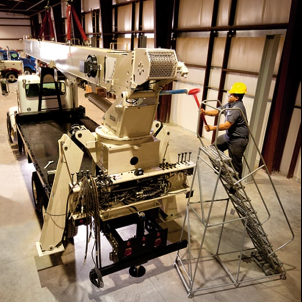 Techs installing crane body on truck