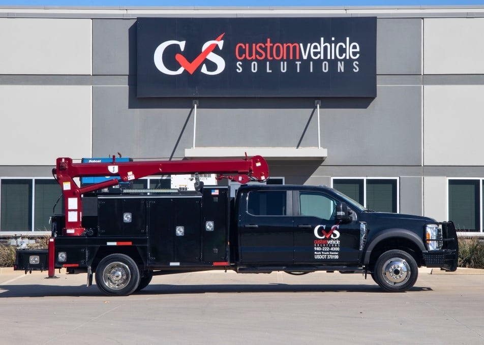 Black mechanics truck with red crane