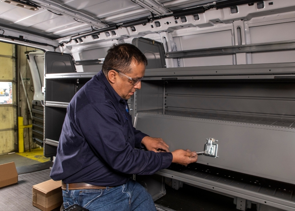 Technician installing storage inside cargo van