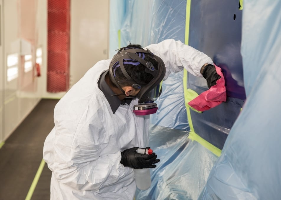 Close up of technician wiping painted truck door with towel