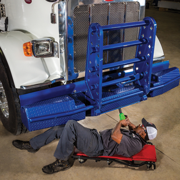 Tech installing grill guard on truck