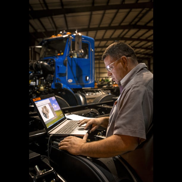 Technician performing pre-delivery inspection