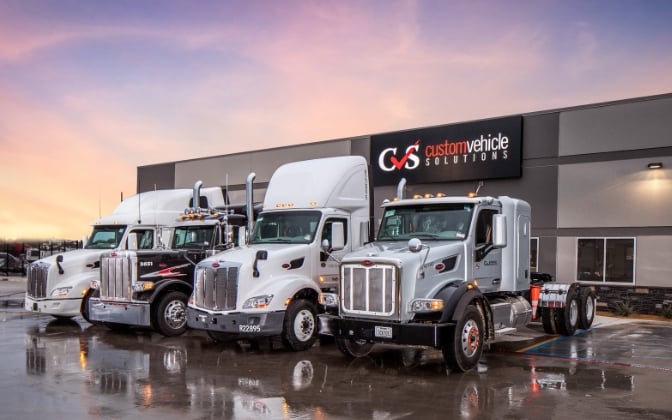 Lineup of trucks outside Custom Vehicle Solutions - Denton