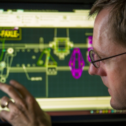 Designer pointing at computer screen