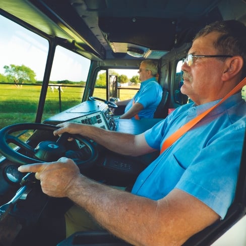 Two drivers in a dual steering truck cab