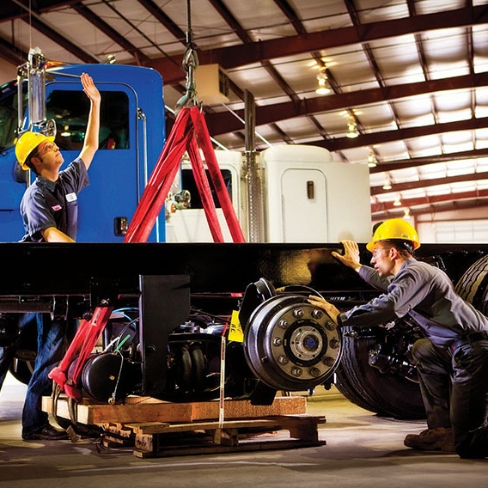 Tech installing components on truck