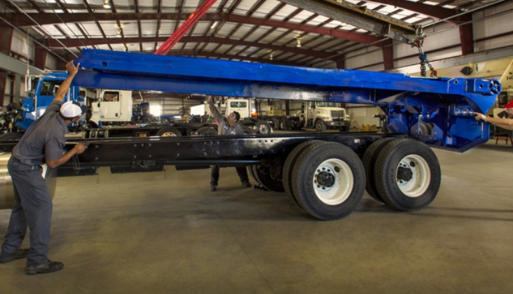 Techs installing special body on truck