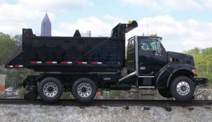 Dump truck modified to drive on railroad tracks