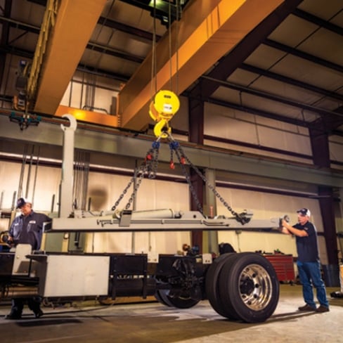 Tech installing truck body with hook lift