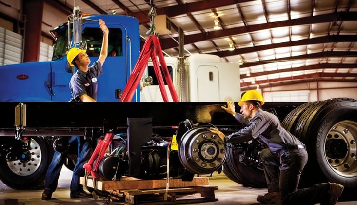 Techs working on truck axles