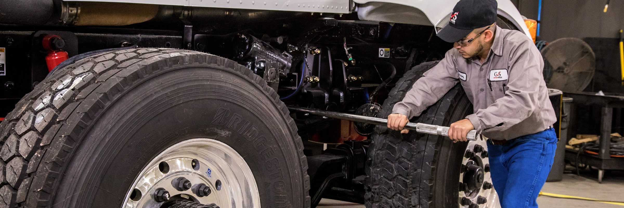 Technician working on truck axle
