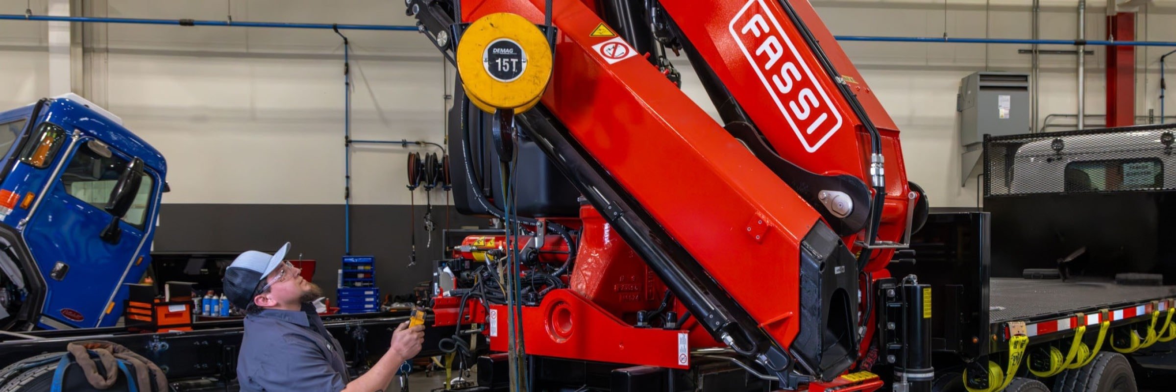 Technician working on Fassi knuckle-boom crane